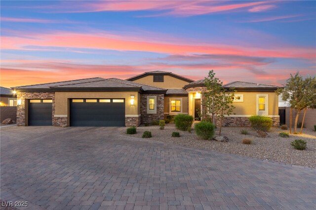 6980 W Meranto Ave, Las Vegas, NV 89178 - view of front of house featuring stone siding, stucco siding, a garage, and decorative driveway