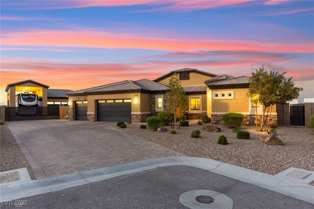 6980 W Meranto Ave, Las Vegas, NV 89178 - view of front of home with stone siding, a garage, decorative driveway, and a gate
