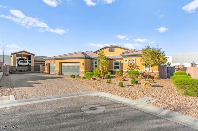 6980 W Meranto Ave, Las Vegas, NV 89178 - view of front of property with stone siding, stucco siding, decorative driveway, and a carport
