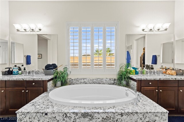6980 W Meranto Ave, Las Vegas, NV 89178 - bathroom featuring two vanities and a bath