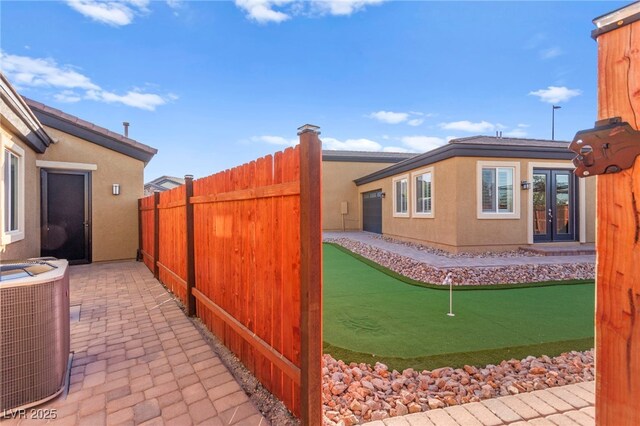 6980 W Meranto Ave, Las Vegas, NV 89178 - view of yard with an area to practice putting, french doors, and a patio