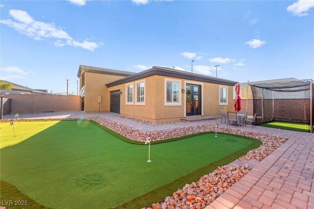 6980 W Meranto Ave, Las Vegas, NV 89178 - back of house featuring a putting area, french doors, a patio area, and a fenced backyard
