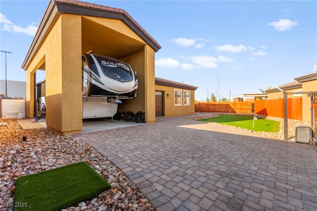 6980 W Meranto Ave, Las Vegas, NV 89178 - fenced backyard with a putting green and a patio area