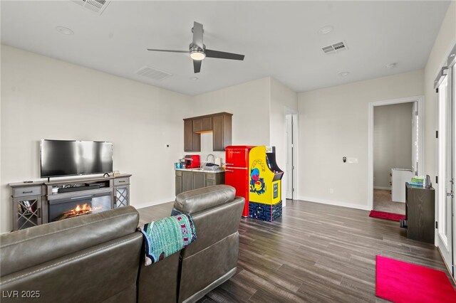 6980 W Meranto Ave, Las Vegas, NV 89178 - living area with a ceiling fan, dark wood-style flooring, and a glass covered fireplace
