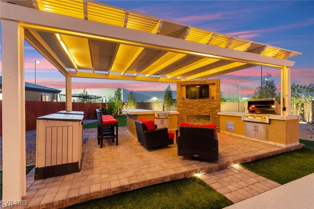6980 W Meranto Ave, Las Vegas, NV 89178 - patio terrace at dusk featuring area for grilling, a patio area, an outdoor living space with a fireplace, and a pergola