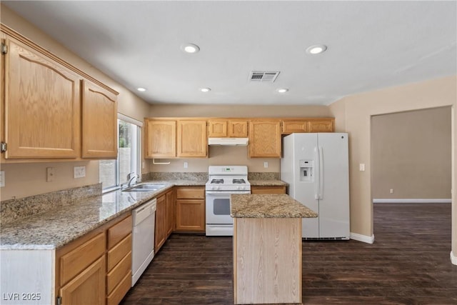 5 Spur Cross Cir, Henderson, NV 89012 - kitchen featuring white appliances, a sink, dark wood-style floors, light brown cabinets, and a kitchen island