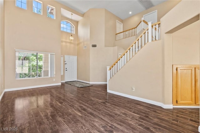 5 Spur Cross Cir, Henderson, NV 89012 - foyer entrance with dark wood finished floors, a towering ceiling, baseboards, and stairway