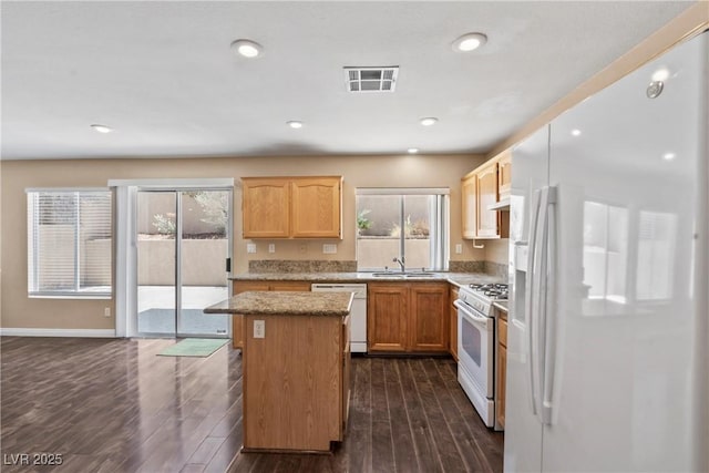 5 Spur Cross Cir, Henderson, NV 89012 - kitchen featuring white appliances, a sink, a center island, dark wood-style floors, and recessed lighting