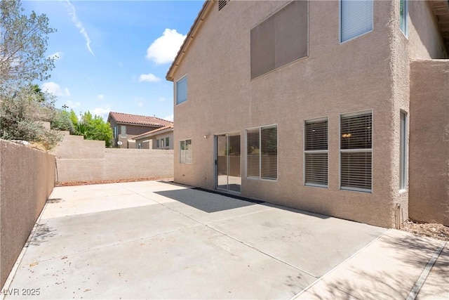5 Spur Cross Cir, Henderson, NV 89012 - back of property with stucco siding, a fenced backyard, and a patio