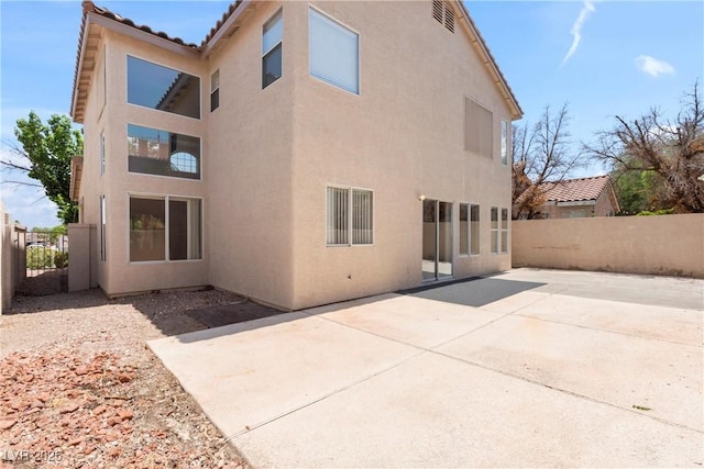 5 Spur Cross Cir, Henderson, NV 89012 - back of house with stucco siding and a patio area