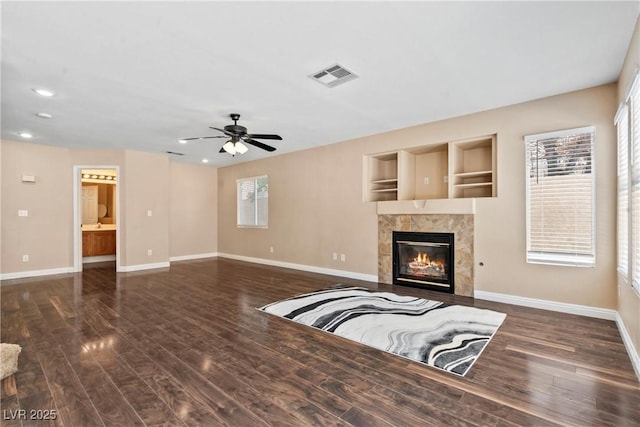 5 Spur Cross Cir, Henderson, NV 89012 - unfurnished living room featuring baseboards, wood finished floors, a ceiling fan, a fireplace, and recessed lighting