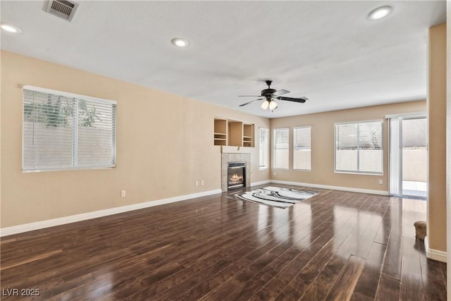 5 Spur Cross Cir, Henderson, NV 89012 - unfurnished living room with baseboards, a ceiling fan, dark wood-style floors, a tile fireplace, and recessed lighting
