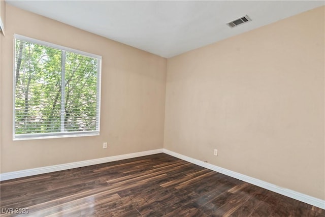 5 Spur Cross Cir, Henderson, NV 89012 - spare room with healthy amount of natural light, baseboards, and dark wood-style floors