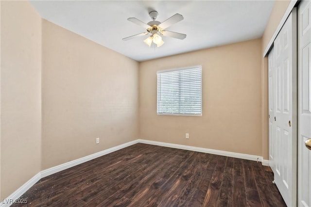 5 Spur Cross Cir, Henderson, NV 89012 - unfurnished bedroom with a closet, dark wood-style flooring, baseboards, and ceiling fan