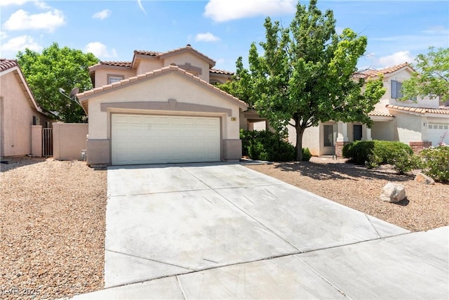 5 Spur Cross Cir, Henderson, NV 89012 - mediterranean / spanish house with driveway, stucco siding, a tiled roof, an attached garage, and a gate