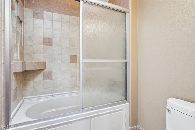 9111 W Stephen Ave, Las Vegas, NV 89149 - bathroom featuring toilet, shower / bath combination with glass door, and a textured wall