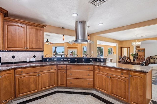9111 W Stephen Ave, Las Vegas, NV 89149 - kitchen with island range hood, black electric stovetop, brown cabinetry, hanging light fixtures, and recessed lighting