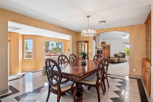 9111 W Stephen Ave, Las Vegas, NV 89149 - dining area featuring granite floors, arched walkways, baseboards, and plenty of natural light