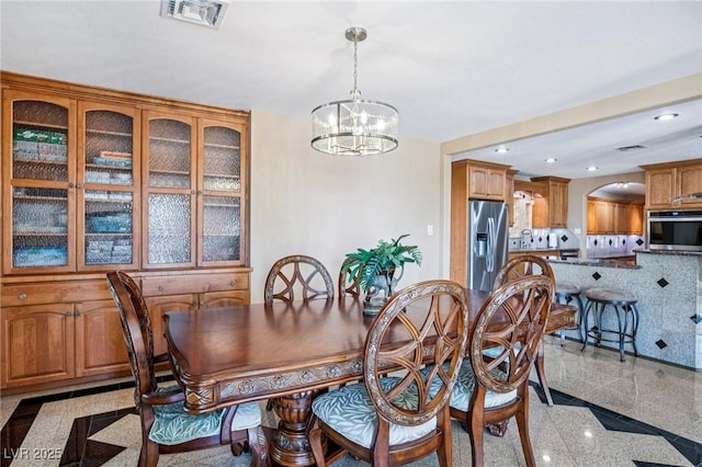 9111 W Stephen Ave, Las Vegas, NV 89149 - dining room featuring a chandelier, recessed lighting, granite floors, and arched walkways
