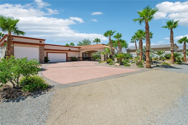 9111 W Stephen Ave, Las Vegas, NV 89149 - mediterranean / spanish-style home with concrete driveway, stucco siding, a garage, and stone siding