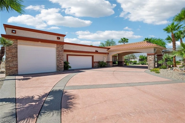 9111 W Stephen Ave, Las Vegas, NV 89149 - view of front of home featuring stucco siding, stone siding, a garage, and driveway