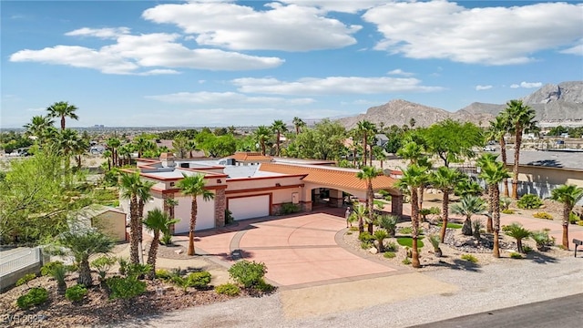 9111 W Stephen Ave, Las Vegas, NV 89149 - view of front of property with a garage, a mountain view, concrete driveway, and stucco siding