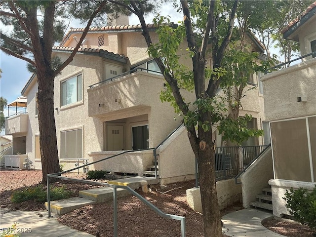 5222 Mandalay Springs Dr Unit 202, Las Vegas, NV 89120 - view of side of home featuring stucco siding