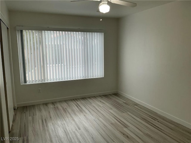 5222 Mandalay Springs Dr Unit 202, Las Vegas, NV 89120 - empty room with wood finished floors, a ceiling fan, and baseboards