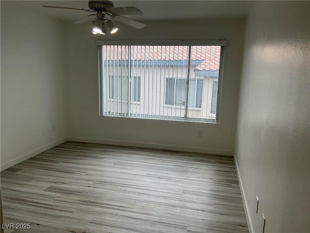 5222 Mandalay Springs Dr Unit 202, Las Vegas, NV 89120 - empty room with a ceiling fan, wood finished floors, and baseboards