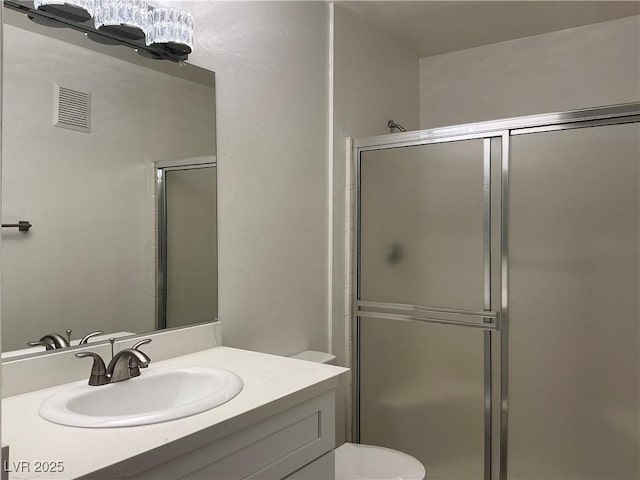 5222 Mandalay Springs Dr Unit 202, Las Vegas, NV 89120 - bathroom featuring a shower stall, vanity, and toilet