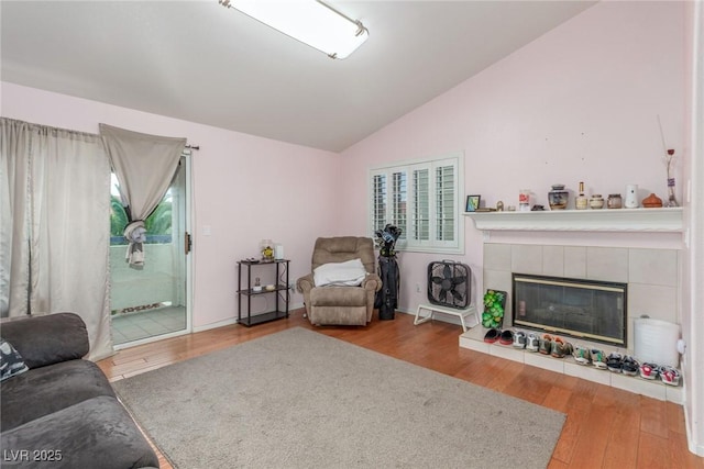 2725 S Nellis Blvd Unit 2168, Las Vegas, NV 89121 - living area featuring vaulted ceiling, wood finished floors, and a tile fireplace