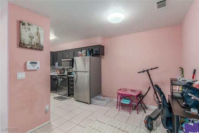 2725 S Nellis Blvd Unit 2168, Las Vegas, NV 89121 - kitchen with appliances with stainless steel finishes, light tile patterned flooring, and baseboards