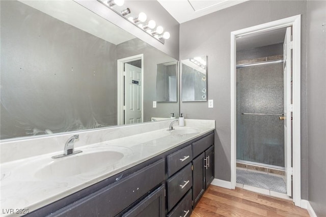 2725 S Nellis Blvd Unit 2168, Las Vegas, NV 89121 - full bathroom with double vanity, wood finished floors, a shower with door, and baseboards
