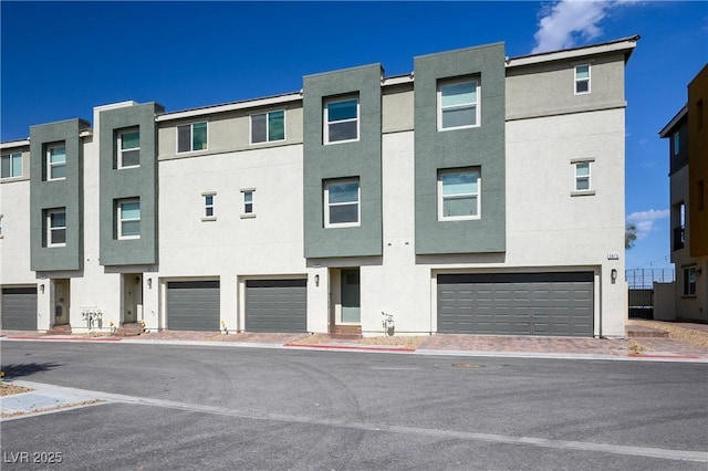 3880 Enchanted Sky St, Las Vegas, NV 89129 - view of front facade featuring a garage and stucco siding