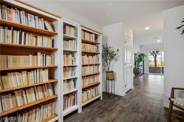 3880 Enchanted Sky St, Las Vegas, NV 89129 - living area featuring wall of books, wood finished floors, and recessed lighting