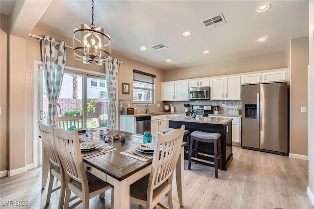 9853 Bangalore Ct, Las Vegas, NV 89148 - dining room featuring a chandelier, light wood finished floors, recessed lighting, and baseboards