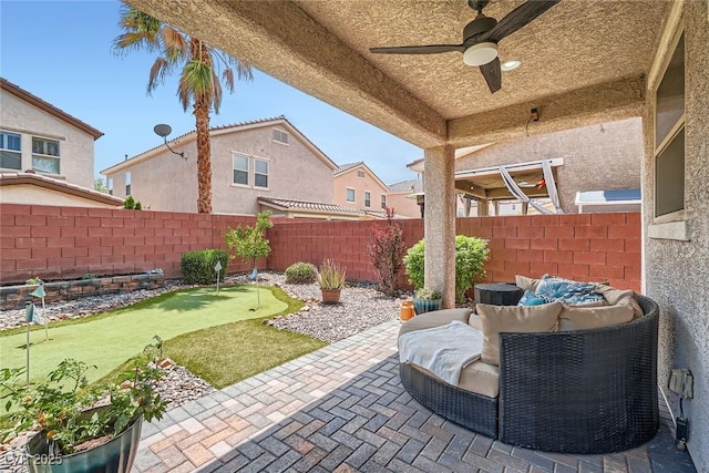 9853 Bangalore Ct, Las Vegas, NV 89148 - fenced backyard featuring a putting area, ceiling fan, and a patio area