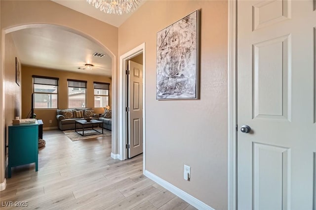 9853 Bangalore Ct, Las Vegas, NV 89148 - corridor featuring arched walkways, light wood-style floors, and baseboards