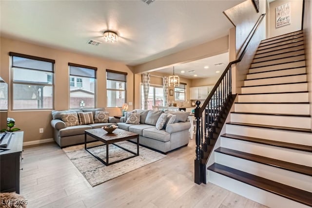 9853 Bangalore Ct, Las Vegas, NV 89148 - living room with stairs, a chandelier, light wood-style floors, baseboards, and recessed lighting