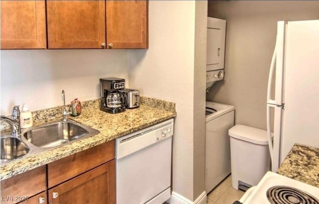 4200 S Valley View Blvd Unit 2081, Las Vegas, NV 89103 - kitchen with white appliances, brown cabinetry, light tile patterned floors, light stone counters, and a sink