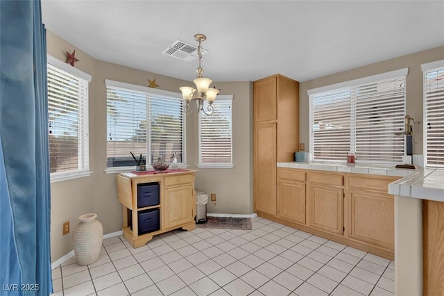 4628 Standing Bluff Way, Las Vegas, NV 89130 - kitchen featuring tile countertops, healthy amount of natural light, and baseboards