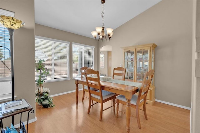 4628 Standing Bluff Way, Las Vegas, NV 89130 - dining space featuring arched walkways, healthy amount of natural light, light wood-style floors, and baseboards