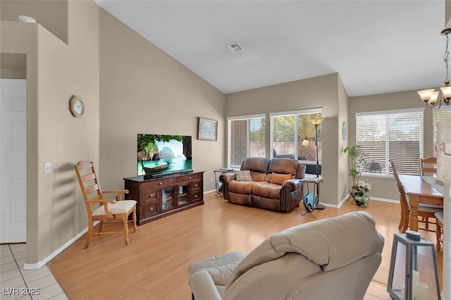 4628 Standing Bluff Way, Las Vegas, NV 89130 - living area with a chandelier, baseboards, light wood-style floors, and high vaulted ceiling