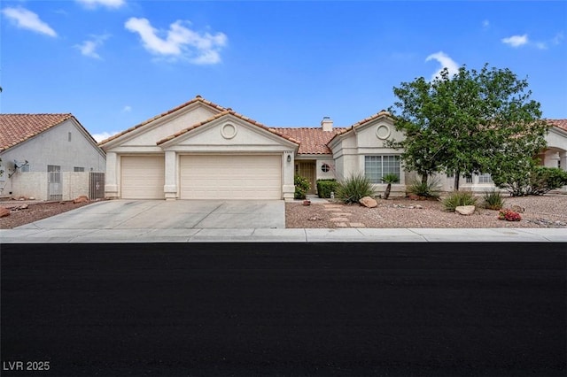 4628 Standing Bluff Way, Las Vegas, NV 89130 - view of front of property featuring a tile roof, an attached garage, driveway, and stucco siding