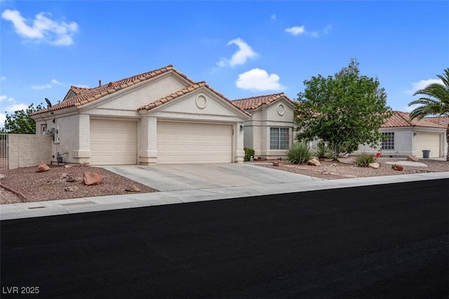 4628 Standing Bluff Way, Las Vegas, NV 89130 - mediterranean / spanish-style house featuring a garage, a tile roof, concrete driveway, and stucco siding