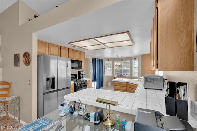 4628 Standing Bluff Way, Las Vegas, NV 89130 - kitchen with stainless steel fridge with ice dispenser, black microwave, tile counters, and range with gas stovetop