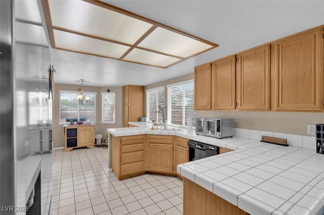 4628 Standing Bluff Way, Las Vegas, NV 89130 - kitchen with black dishwasher, a peninsula, light tile patterned flooring, a sink, and tile countertops