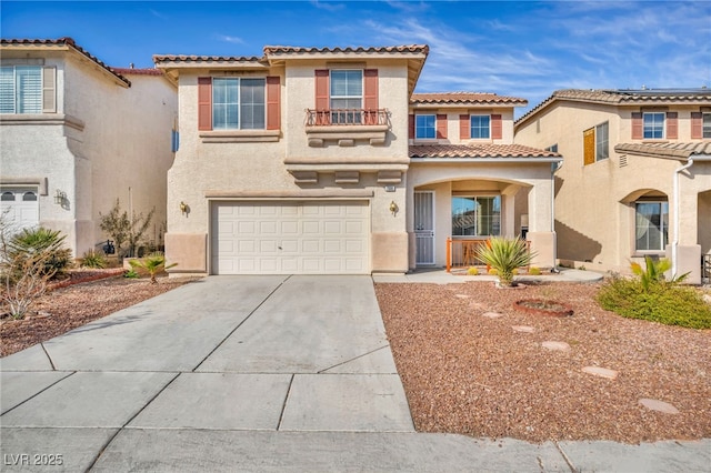 7886 Palace Monaco Ave, Las Vegas, NV 89117 - view of front of home featuring a garage, driveway, stucco siding, a tile roof, and a balcony