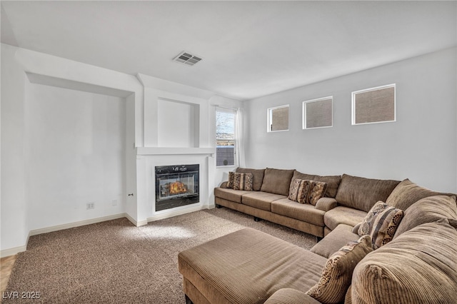 7886 Palace Monaco Ave, Las Vegas, NV 89117 - living area with a glass covered fireplace, light carpet, and baseboards