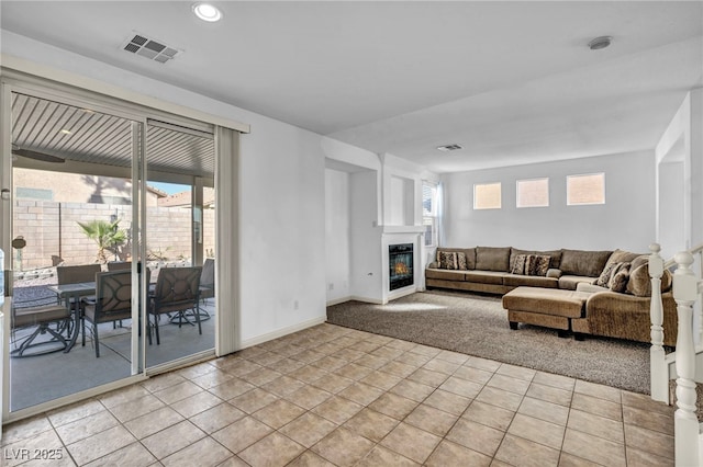 7886 Palace Monaco Ave, Las Vegas, NV 89117 - living room featuring a glass covered fireplace, baseboards, and recessed lighting